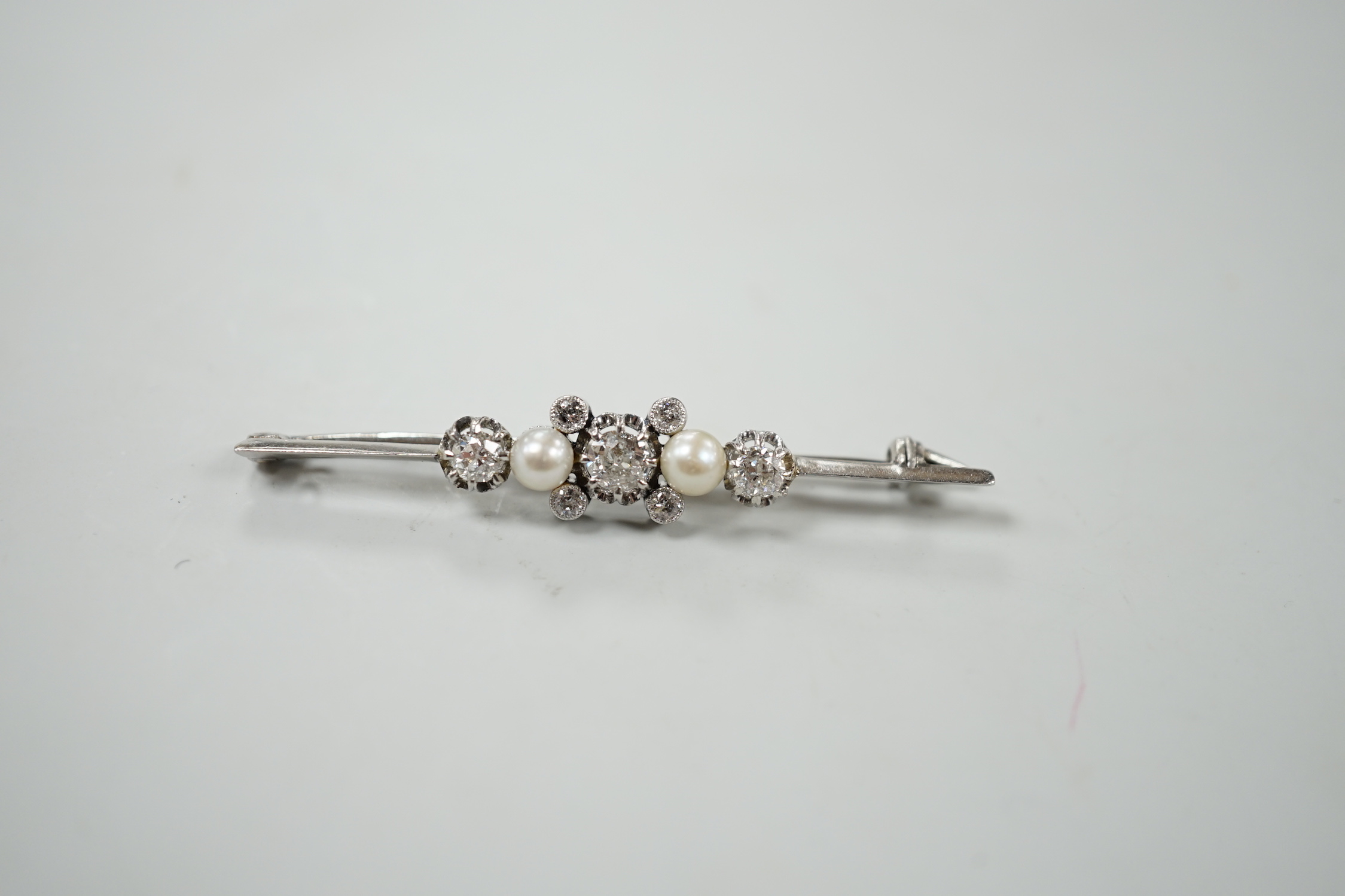 A white metal, diamond and cultured pearl cluster set bar brooch, 52mm, gross weight 6.2 grams.